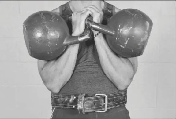 Figure 2.10 the lifting belt is worn loose and low on the hips below the waist so that the lifter can place the elbows between the body and the inside of the belt.